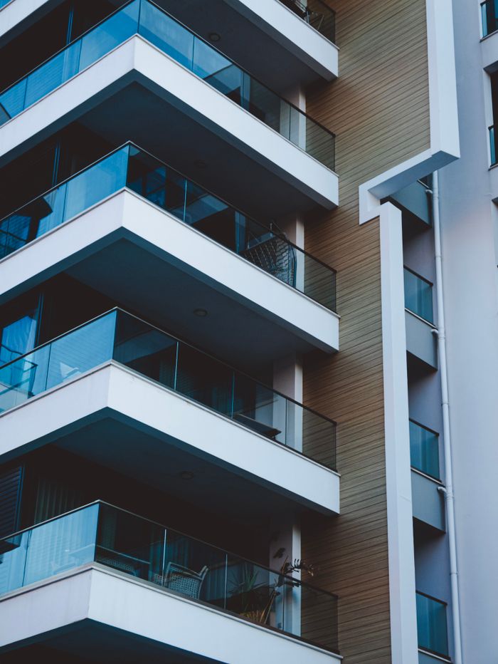 Close-up of a modern residential skyscraper with sleek balconies, showcasing urban architecture.