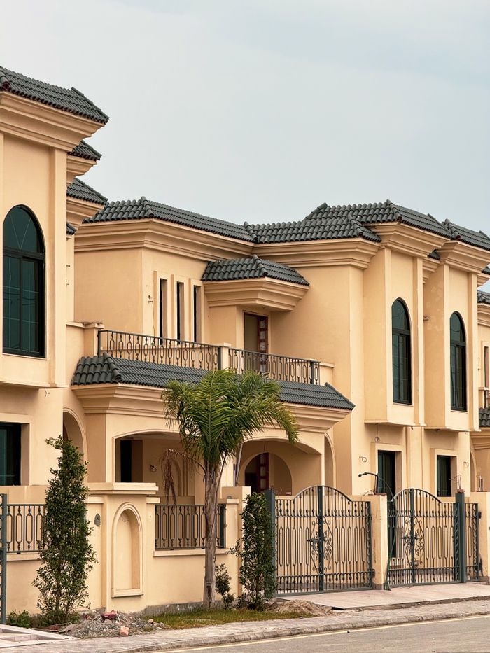 Charming Mediterranean villa with arched windows and detailed exterior design.